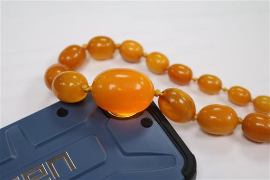 Three assorted single strand graduated amber bead necklaces.